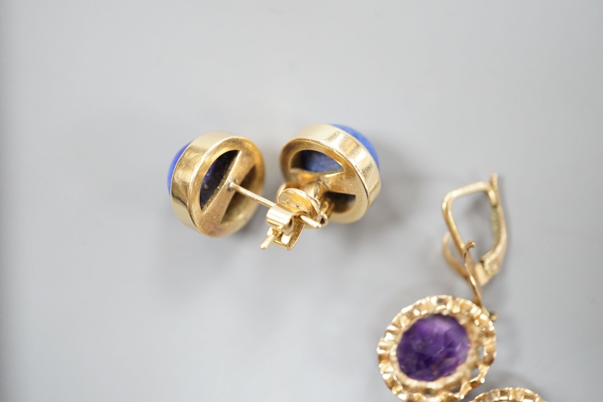 A modern pair of 14k yellow metal and amethyst set drop earrings, 29mm and a similar pair of lapis lazuli set earrings, gross weight 13.9 grams.